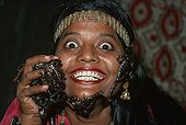 Girl snake charmer with scorpions on her face India