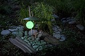 Garden lightning in middle of pebbles at night