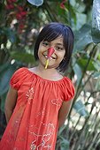 Clowning girl with a flower of Heliconia Sumatra 