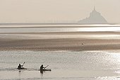 Kayaks in front of the Mont Saint Michel at sunset France