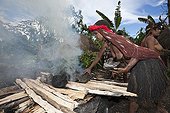 Dani Tribe heat Stones in Fire for Earth Oven Indonesia ; Barapen Ceremony