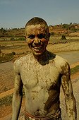 Man working in muddy rice fields Madagascar