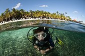 Diver on the beach of the resort Harbour Village in Bonaire