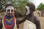Young Karo woman getting make-up, facial paintings, Omo river valley, Southern Ethiopia, Africa
