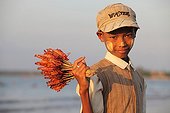 Boy selling Gambas Chaung Tha Beach in Burma