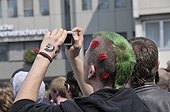Punk taking a photograph at a NPD rally in Ulm, Baden-Wuerttemberg, Germany, Europe