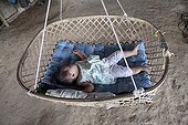 Baby taking a nap in a hammock bamboo in Laos