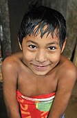 Wet boy coming out of the shower wrapped in a towel, Slum Area Plan 3000, Santa Cruz, Bolivia, South America
