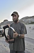 Veterinarian with a radio collar for a Lion in Namibia ; Philip (Flip) Stander, NGO "Desert Lion". Works in north-west.