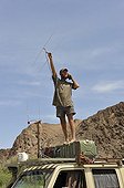 Veterinarian in the footsteps of Lions in Namibia ; Philip (Flip) Sander, veterinarian for the NGO "Desert Lion" listens for signals from satellite collars.