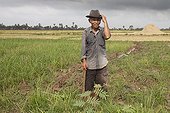 Farmer maintaining irrigation ditches Cambodia 