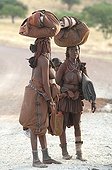 Himba women starting trip Namibia  ; The himbas women go often for long journeys with just the minimum on their heads, a specific freedom of this people.
