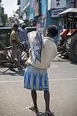 Man carrying a Fish Market Goubert Tamil Nadu India 