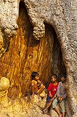 Children in a trunk at Ta Phrom Temple at Angkor in Cambodia ; 