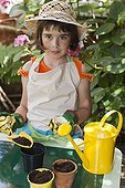 Little girl gardening on a garden terrace