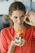 Close-up of a woman holding fruit salad