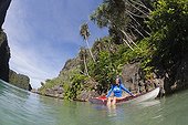 Woman explores and snorkels karst islands by kayak Indonesia
