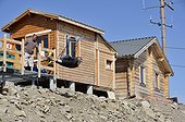 Tourist on the largest Tyrolean of Europe Alps France ; Zipline from the top of Drouvet (2655 m) and Long Lake (2500 m), its length is 1870 meters