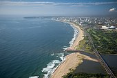 Aerial view of Durban from above Umgeni River Mouth RSA ; showing The Moses Mabhida Stadium and city in the background