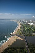 Aerial view of Durban from above Umgeni River Mouth RSA ; showing The Moses Mabhida Stadium and city in the background