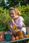 Little girl playing in a kitchen garden