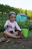 Little girl playing in a kitchen garden