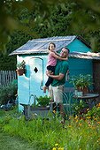 Gardener and little girl in a kitchen garden