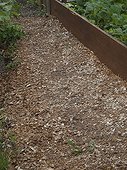 Mulching summer in an organic garden France ; Woodchips