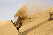 Sand boarding in the dunes of the Namib Desert 