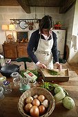 Woman cooking and vegetables in a kitchen