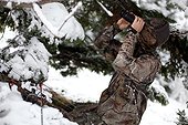 Bow hunter on the lookout in winter PNR Chartreuse France 