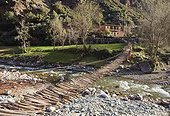 Plank bridge accessing the Ourika Valley - Atlas Morocco ; a prelude to the High Atlas mountains and a popular weekend escape for Marrakchis