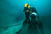 Diver cleaning an anode  - Aquarius Reef Base Florida ; umbilical diver moving a NASA prototype camera