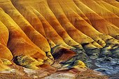 The Painted Hills - John Day Fossil Beds National Monument ; Eroded hills of volcanic ash brightly colored with oxides of iron and manganese, and lignite - tertiary era, to - 25 My