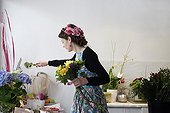 Florist preparing a bouquet in her shop