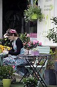Florist in front of her shop
