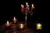 Candles and candlestick in garden at night