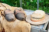 Hat and garden clogs on hessian