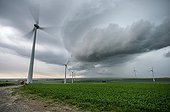 Storm front and wind turbines in the countryside - France
