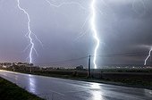 Storm in a very powerful Cevennes episode - France  ; Thunderstorm and lightning strikes near a fruit tree. Two visible upward tracers. 