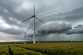 Wind turbines and storm front over the countryside - France 