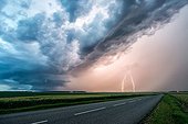 Supercell and lightning over the countryside - France ; Two positive lightnings are in hail precipitation.