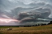Thunderstorm and lightning above the evening countryside - France ; Architecture rarely seen cover. 