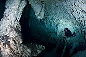 Scuba diver in Gran Cenote - Yucatan Mexico ; As this decorated room is near an exit to the surface, certified open water divers are permitted here, whereas exploring true caves requires additional training and specialized equipment
