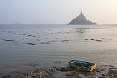 Rowing boat and Mont Saint-Michel at high tide - France