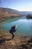 Femme pêchant une Perche en hiver - Franche-Comté France ; Pêche du carnassier au leurre artificiel