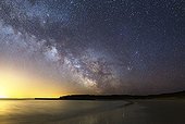 Milky Way above the island of Houat - Brittany France ; Notice the black shape just right of center of the Milky Way. It evokes a rearing horse whose legs pointing towards the star Antares, around which are visible low nebulosity. 