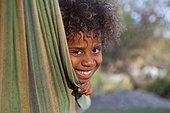 Portrait of girl in a hammock - Tanna Island Vanuatu ; 6 year old girl