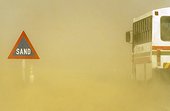 Sand road sign and sandstorm - Namib Desert Namibia ; at the B 2 tarred road