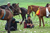 Rider getting ready for a race at the Lapste - Tibet China ; Equestrian Festival Lapste <br>Every year, in june, the villages of a each valley are gathering together for horse races.